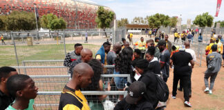 Football fans queueing to get into a match.