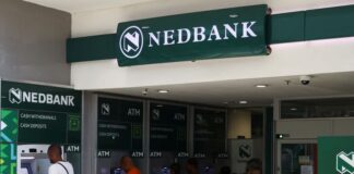 Customers using a Nedbank automated teller machine (ATM) at Trade Route Mall in Lenasia, South Africa